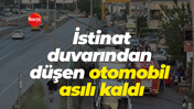 İstinat duvarından alt sokağa düşen otomobil asılı kaldı
