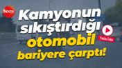 Kamyonun sıkıştırdığı otomobil bariyere çarptı!