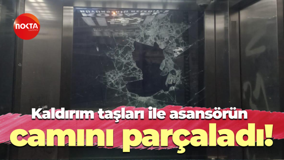 Kaldırım taşları ile asansörün camını parçaladı!